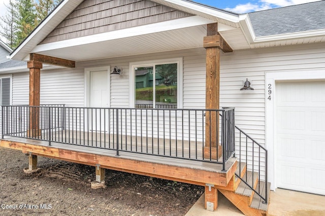 wooden deck featuring a garage