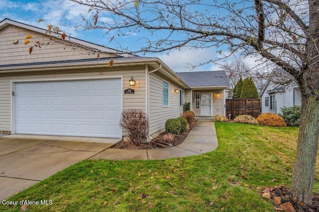 ranch-style house featuring a garage and a front lawn