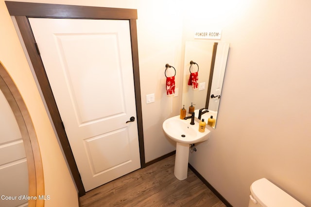 bathroom featuring hardwood / wood-style floors and toilet