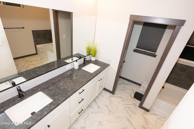 bathroom featuring vanity and a tub