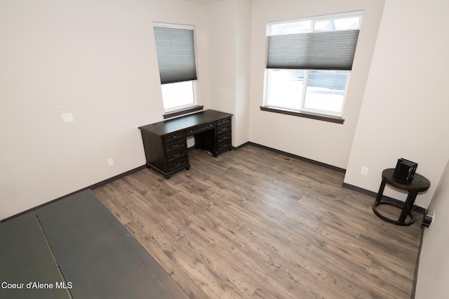 unfurnished office featuring hardwood / wood-style flooring