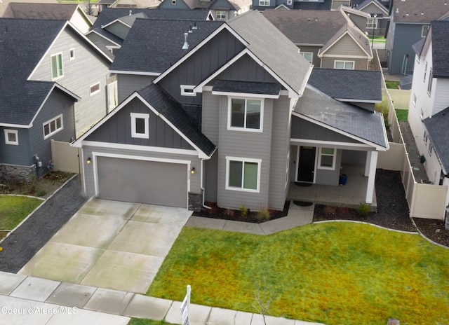 view of front of house featuring a garage and a front lawn