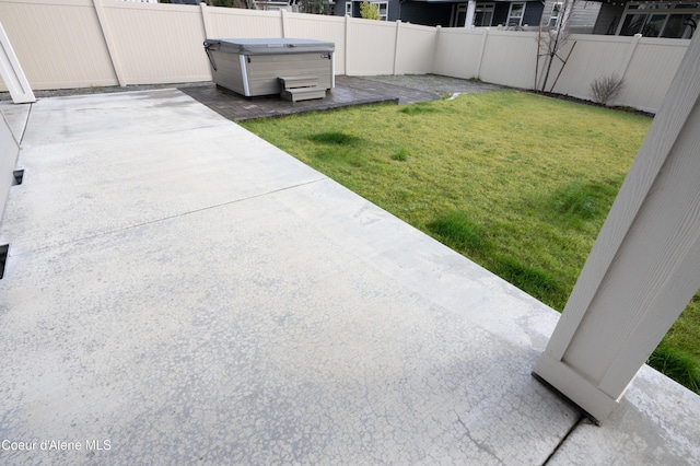 view of yard with a patio area and a hot tub