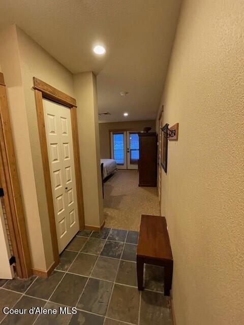 corridor featuring dark tile patterned floors