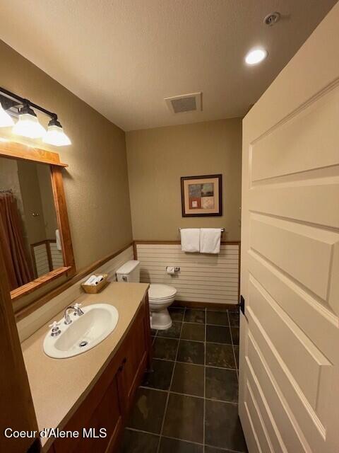 bathroom featuring toilet, vanity, and tile patterned floors