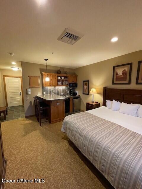 bedroom with dark colored carpet