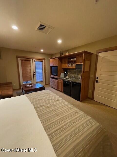 bedroom featuring light colored carpet