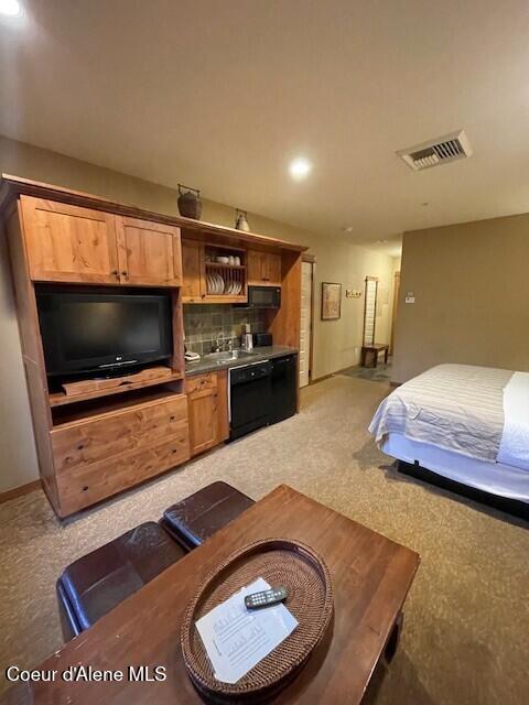 carpeted bedroom featuring sink