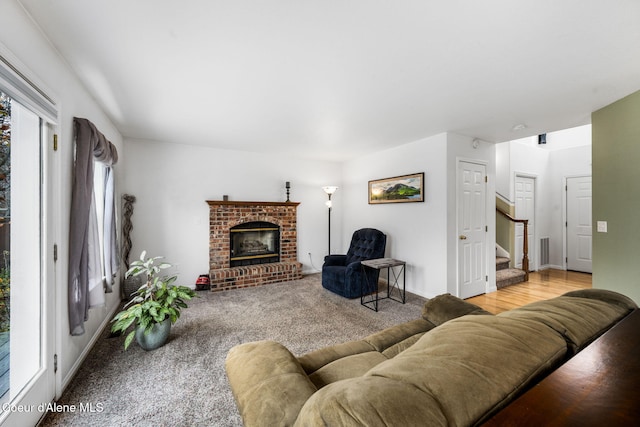 living room featuring a fireplace and light hardwood / wood-style flooring