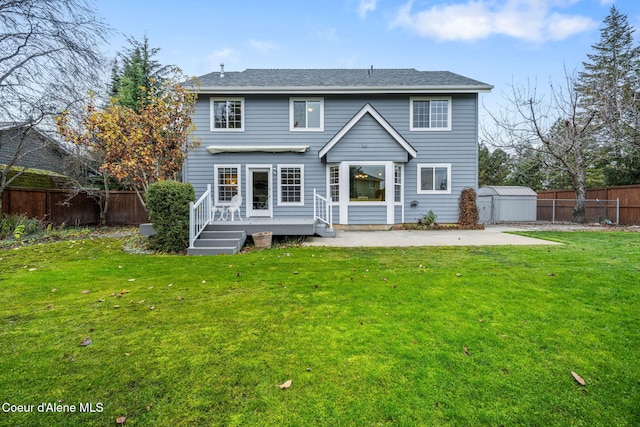 back of property featuring a lawn, a shed, a deck, and a patio