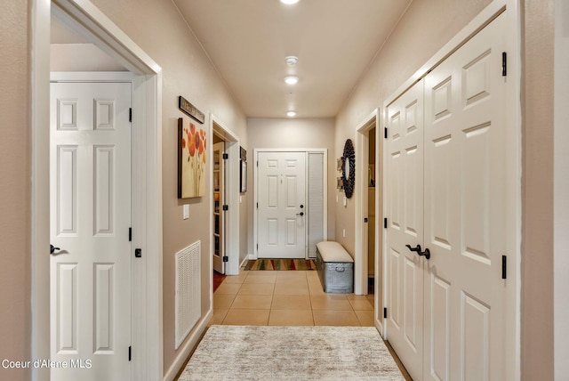 corridor with light tile patterned floors