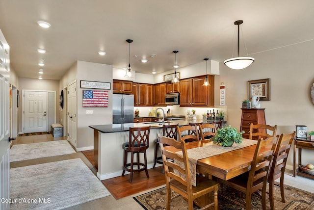 dining area featuring sink and light hardwood / wood-style flooring