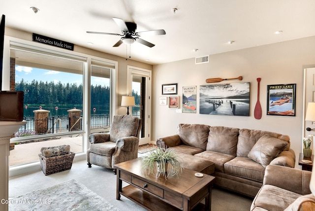 carpeted living room featuring ceiling fan