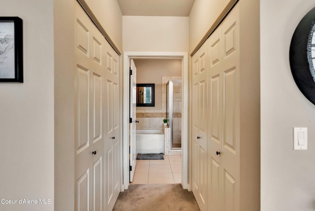 hall with light tile patterned floors