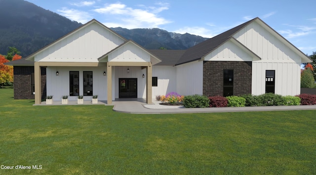 modern farmhouse featuring a mountain view and a front lawn