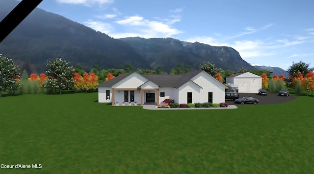 view of front of property with a mountain view and a front lawn