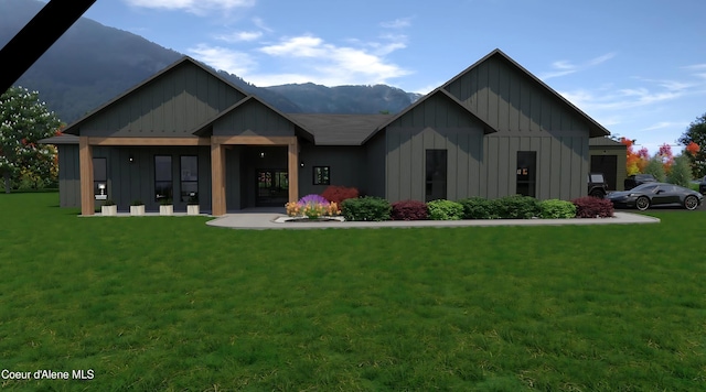 view of front of home with a mountain view and a front yard