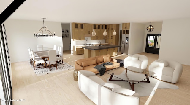 living room featuring a chandelier, sink, and light hardwood / wood-style flooring