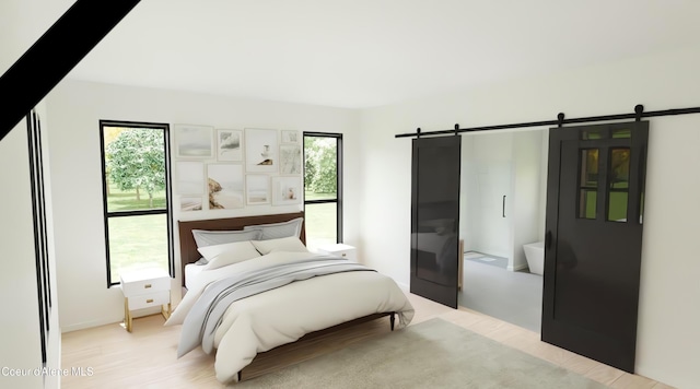 bedroom featuring a barn door and light wood-type flooring