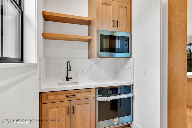 kitchen featuring sink, stainless steel appliances, and tasteful backsplash