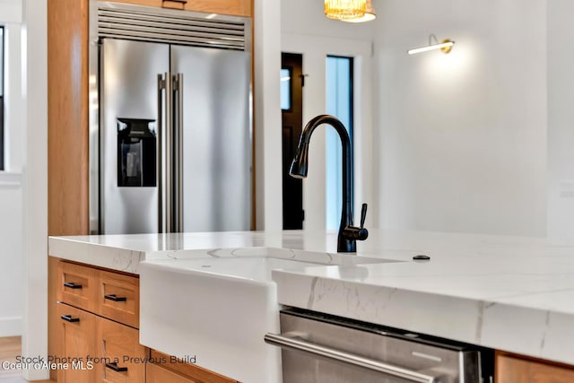 interior space featuring light stone counters and stainless steel appliances