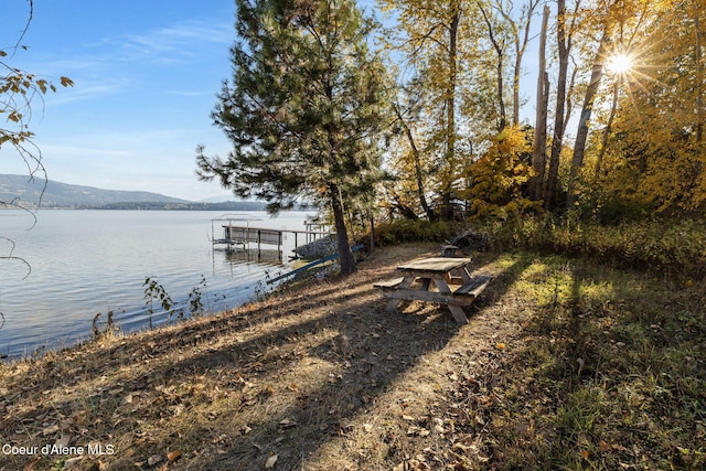 view of dock featuring a water and mountain view