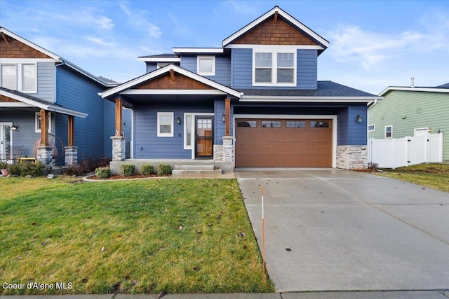 craftsman-style home with a front yard and a garage