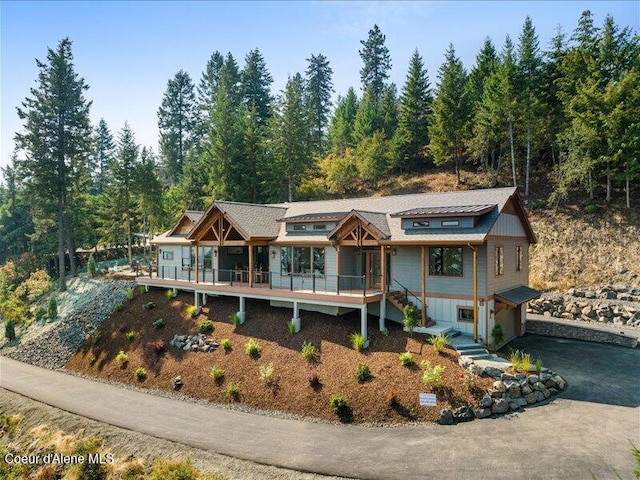 back of property featuring a wooden deck and a garage