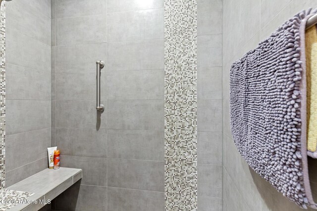 bathroom with tiled shower