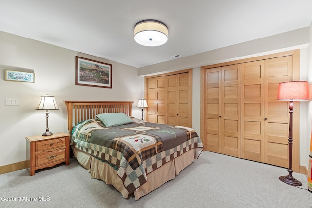 carpeted bedroom with multiple closets