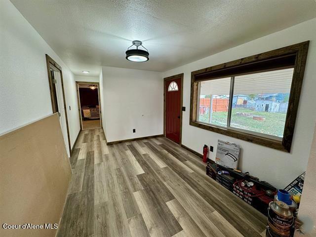 interior space featuring wood-type flooring and a textured ceiling