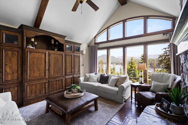 living room with a mountain view, high vaulted ceiling, ceiling fan, beamed ceiling, and dark hardwood / wood-style flooring