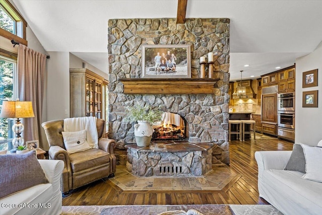 living room with a fireplace, lofted ceiling with beams, and dark wood-type flooring