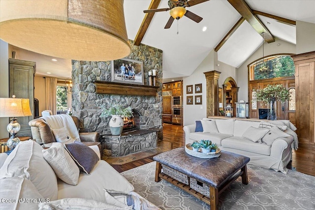 living room featuring dark hardwood / wood-style floors, ceiling fan, high vaulted ceiling, and decorative columns