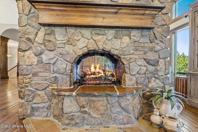 details featuring hardwood / wood-style flooring and a stone fireplace