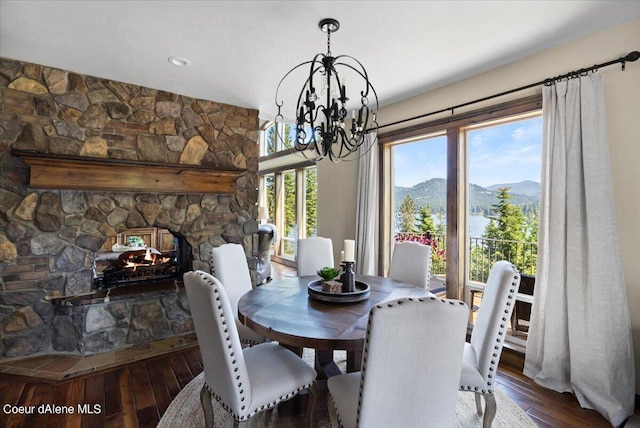 dining area with a mountain view and hardwood / wood-style floors