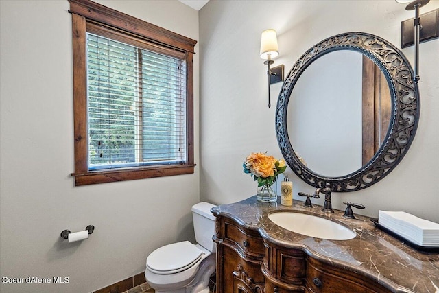 bathroom featuring vanity, toilet, and a wealth of natural light