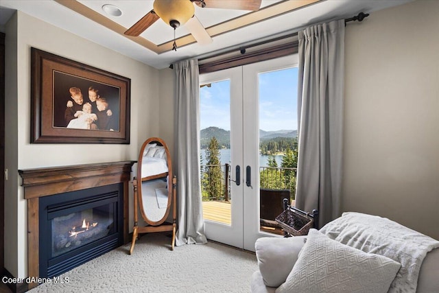 sitting room featuring a wealth of natural light, french doors, ceiling fan, and a mountain view