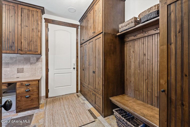 mudroom with a textured ceiling