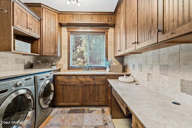 washroom with washer and clothes dryer, cabinets, and sink