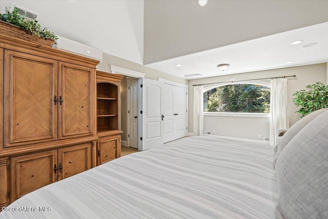 bedroom featuring light colored carpet and vaulted ceiling