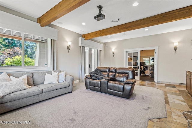 living room featuring beam ceiling, light carpet, a wealth of natural light, and french doors