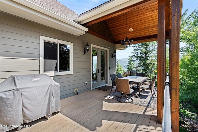 wooden terrace featuring a grill and french doors