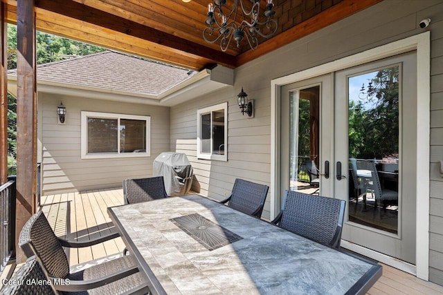 deck with french doors and grilling area