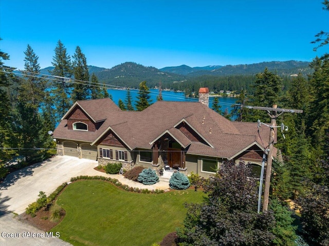 drone / aerial view featuring a water and mountain view