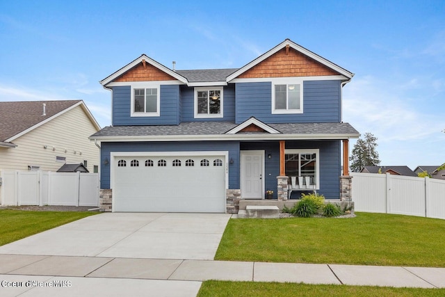 craftsman inspired home with covered porch, a garage, and a front lawn