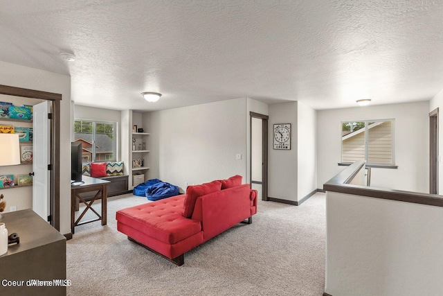 carpeted living room featuring a textured ceiling and built in features