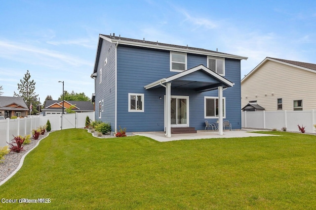 rear view of property with a yard and a patio