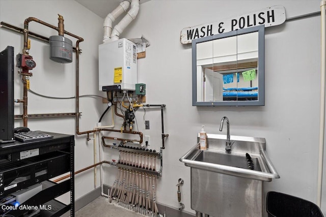 utility room featuring tankless water heater and sink