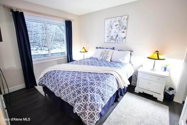 bedroom with wood finished floors and baseboards